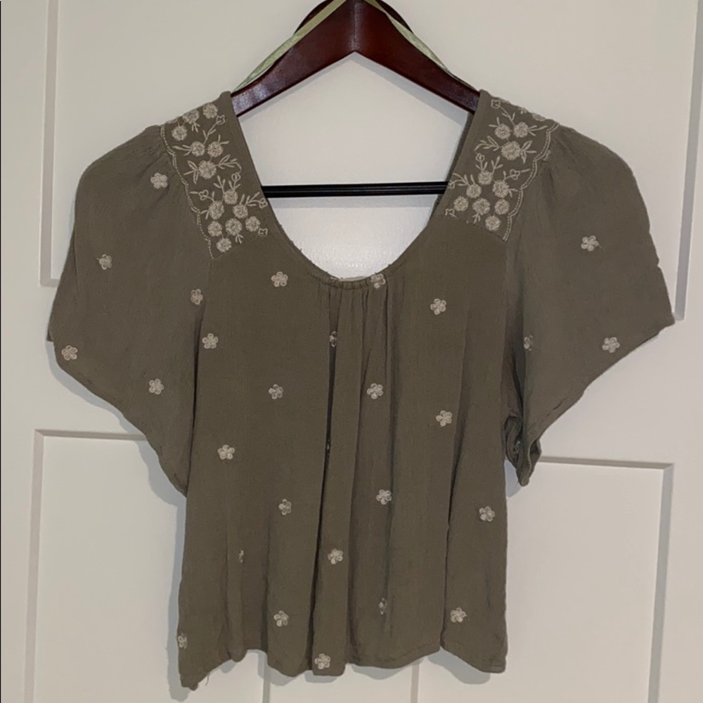 Olive green crop top with white flowers throughout
